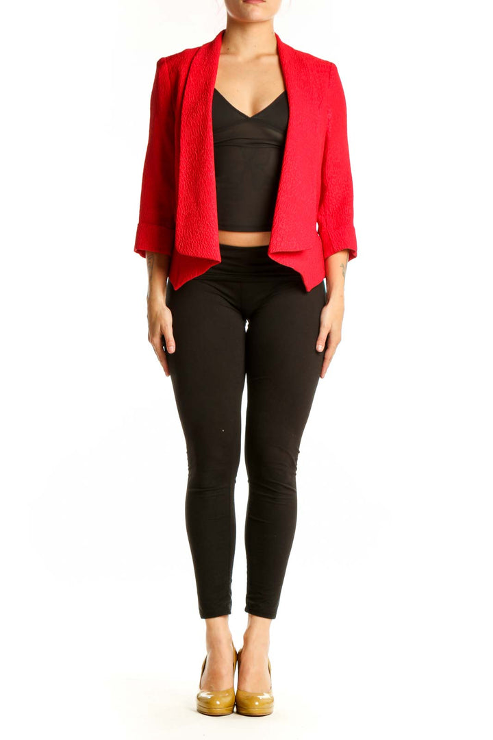 Red textured blazer by Alberto Makali with open-front design and three-quarter sleeves, worn with black crop top