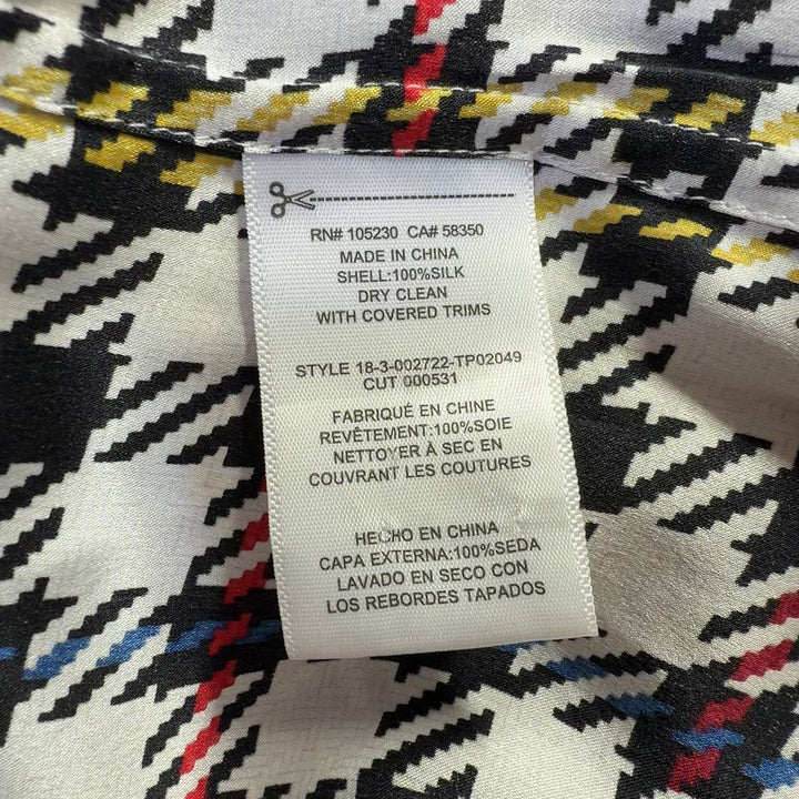 Tag view of multicolor houndstooth silk blouse showing button-up closure and long sleeves