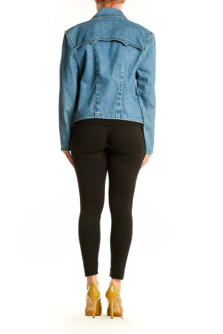 Back view of cropped blue denim blazer showing tailored fit and length