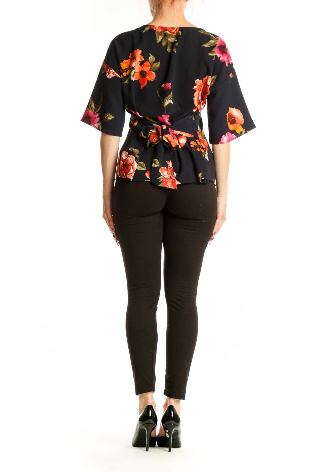 Black floral half sleeve top back view showing botanical print design and relaxed fit silhouette