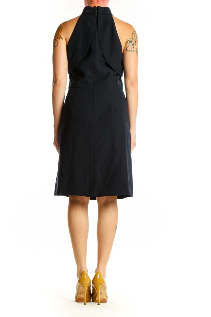 Back view of black halter neck midi dress showing elegant draping and A-line skirt