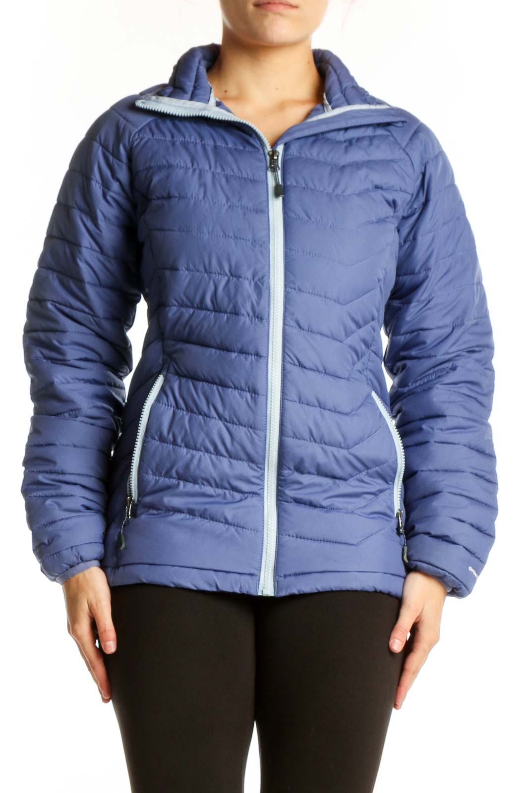 Navy quilted puffer jacket with white trim and full-length zipper, worn with black leggings