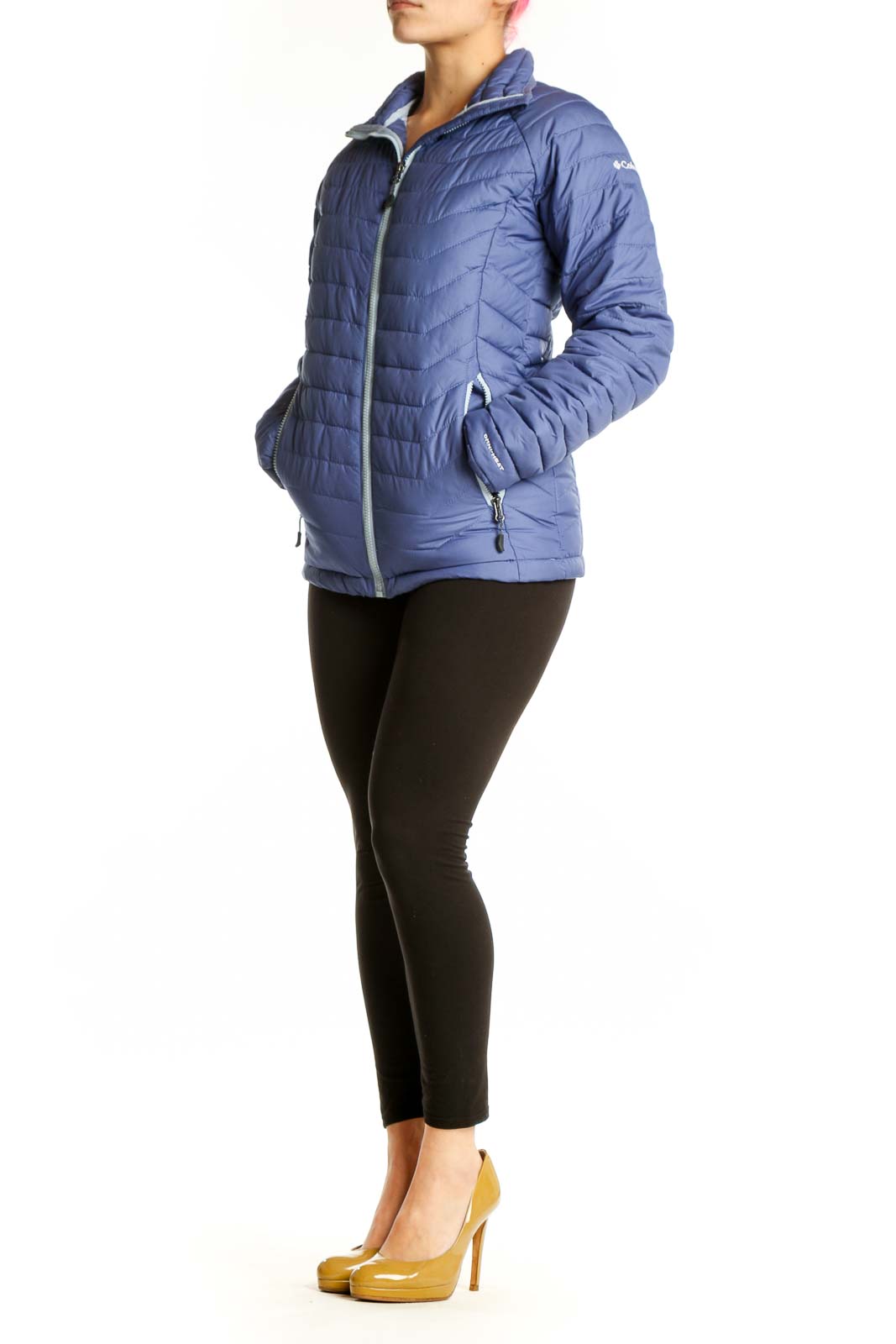 Navy quilted puffer jacket with white trim and full-length zipper, worn with black leggings