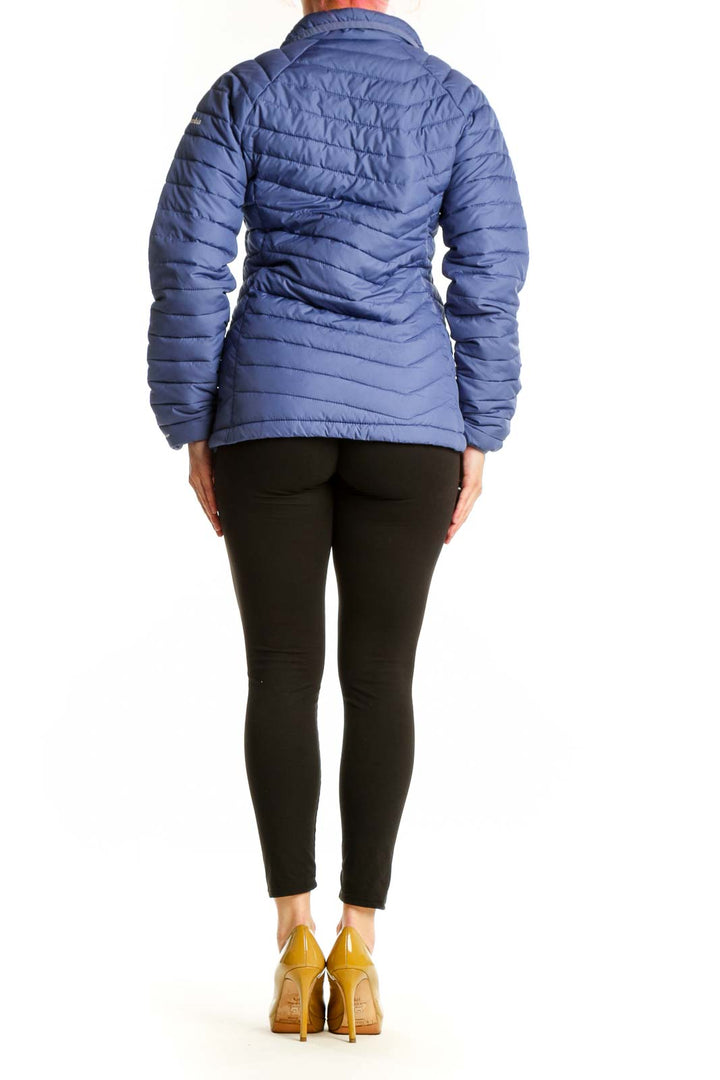 Back view of navy Columbia puffer jacket showing quilted pattern and fitted waist design