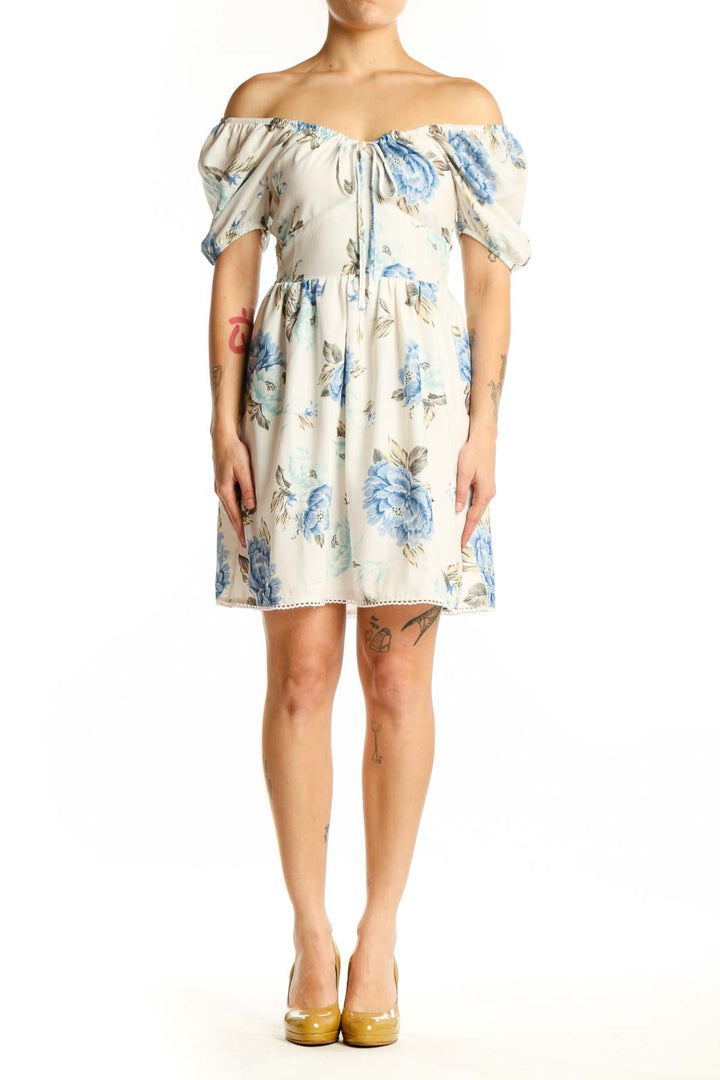 Cream floral off-shoulder dress with blue and green botanical print, short puffed sleeves, and A-line silhouette