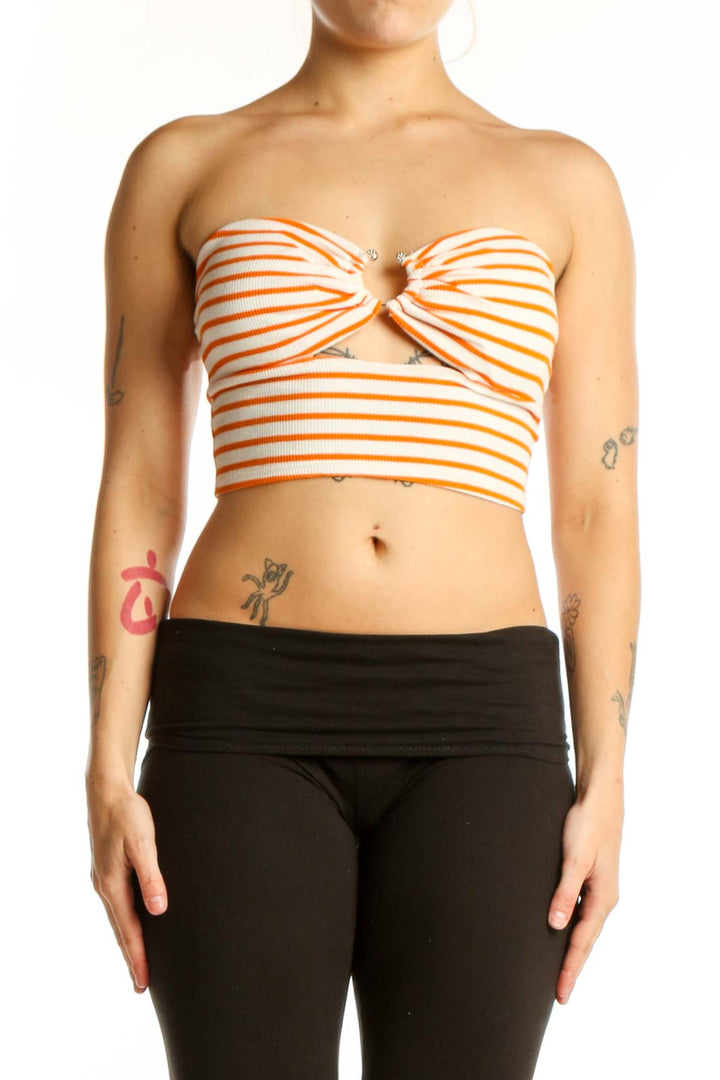 Orange and white striped strapless crop top with sweetheart neckline and center cutout detail, front view