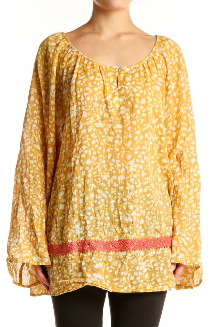 Yellow floral print cotton blouse with bell sleeves and coral trim detail, front view