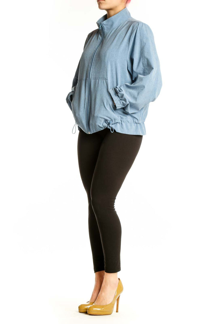 Front view of light blue denim windbreaker jacket with full-length zipper and mock neck collar