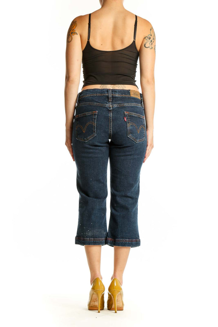 Back view of dark blue Levi's cropped denim jeans showing classic five-pocket design and fitted silhouette