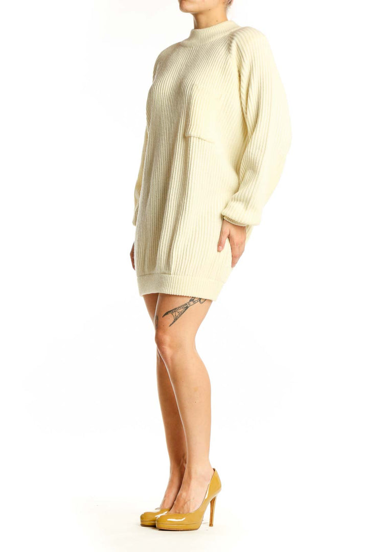 Front view of cream ribbed acrylic sweater dress with crew neckline and long sleeves