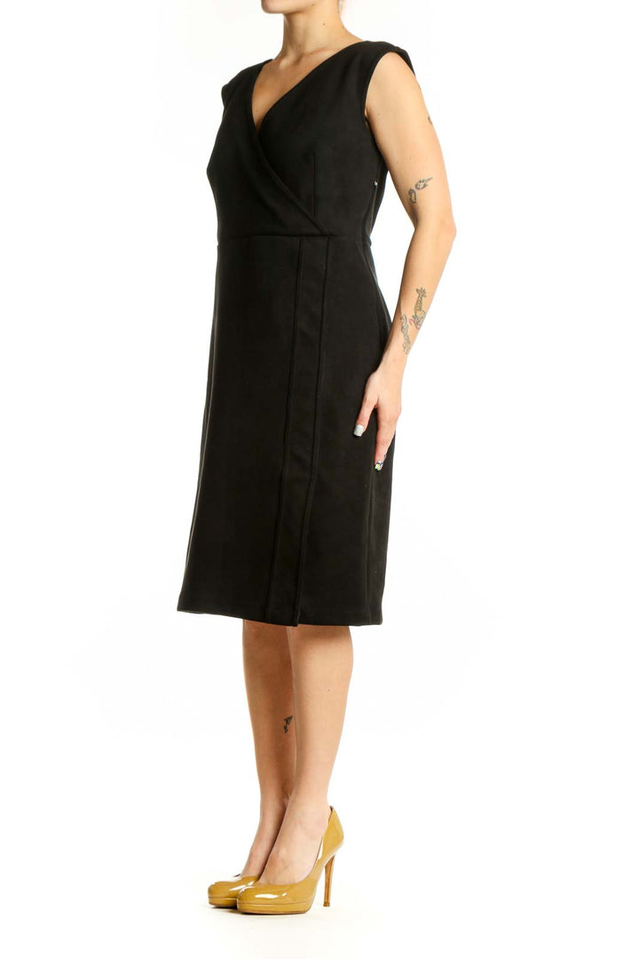 Black wrap V-neck sleeveless petite dress with flattering wrap bodice and knee-length cut