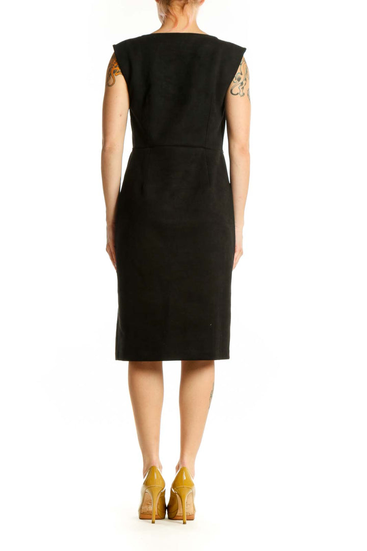 Back view of black wrap petite dress showing wrap design and structured silhouette