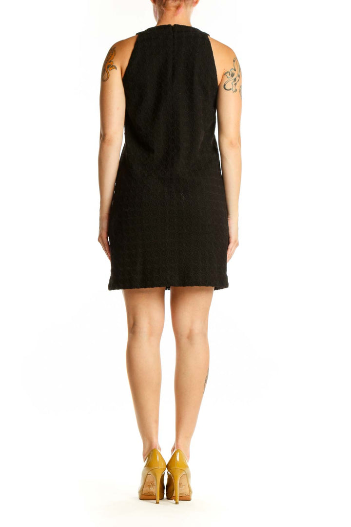 Black sleeveless halter neck dress back view on model