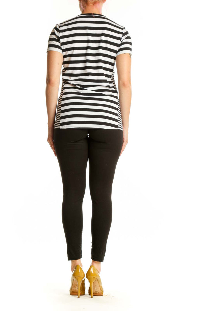 Black and white striped Michael Kors top back view showing fitted silhouette and gold side zip detail