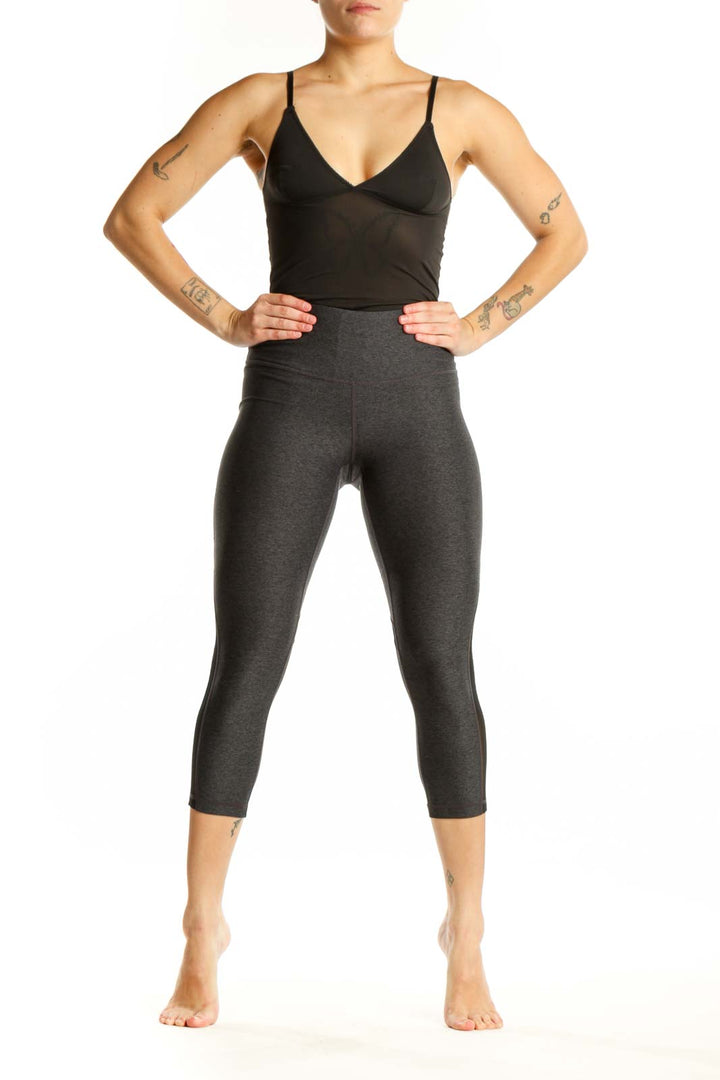 Front view of charcoal capri leggings with mesh panels and high-waisted fit