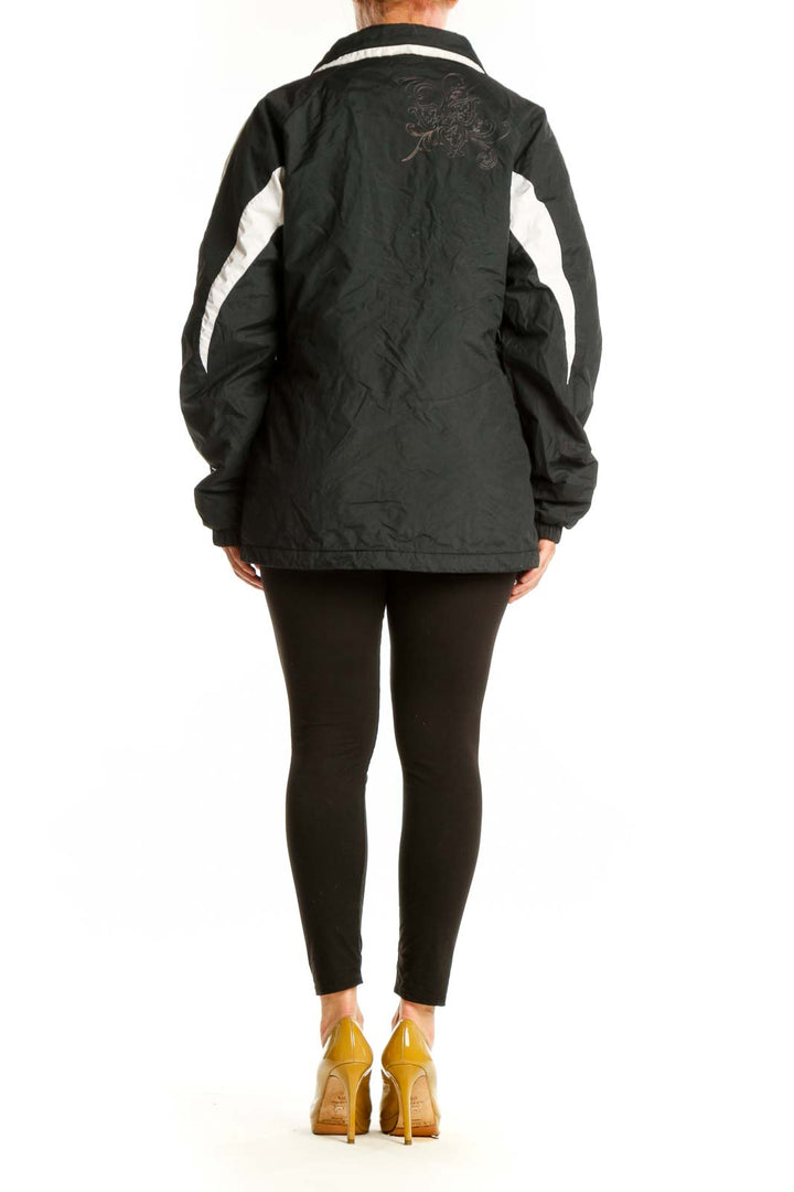 Black Columbia windbreaker jacket with white stripe details, back view showing hooded design and relaxed fit