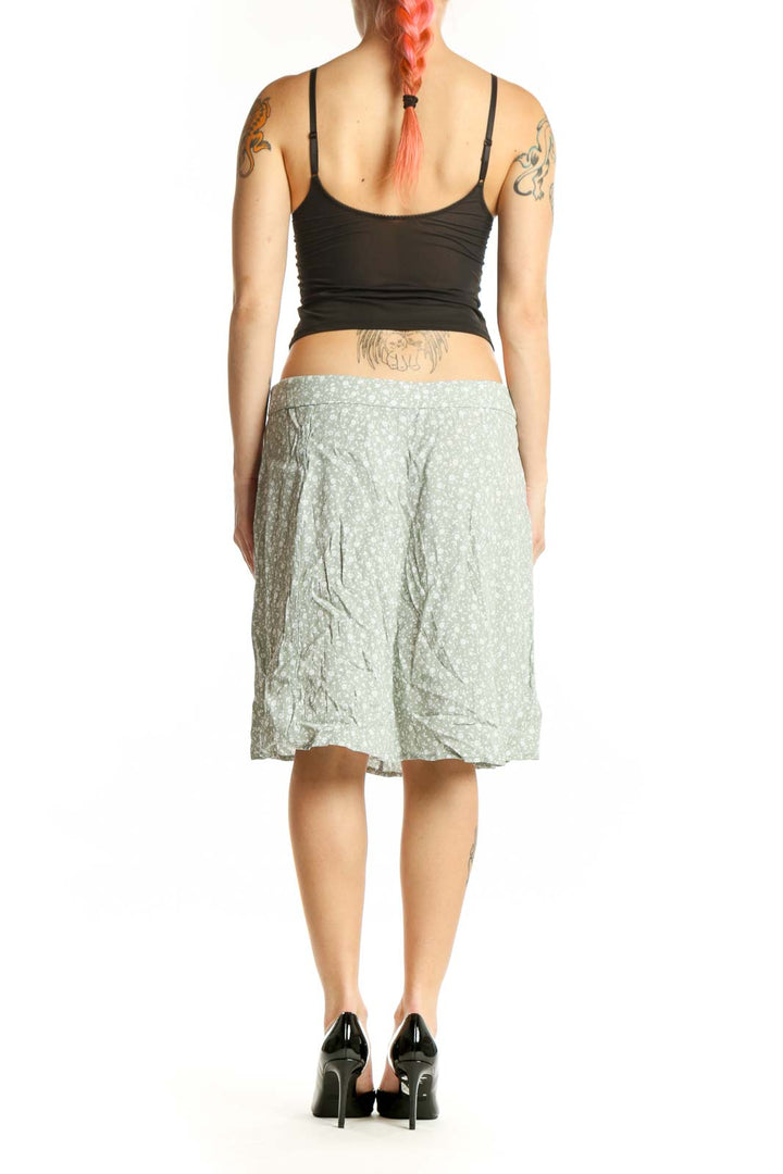 Green floral A-line midi skirt by LOFT, back view displaying draping and knee-length cut