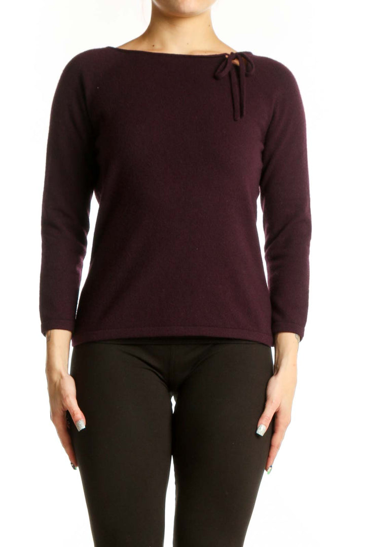 Burgundy long sleeve knit top with tie neckline detail, front view on model