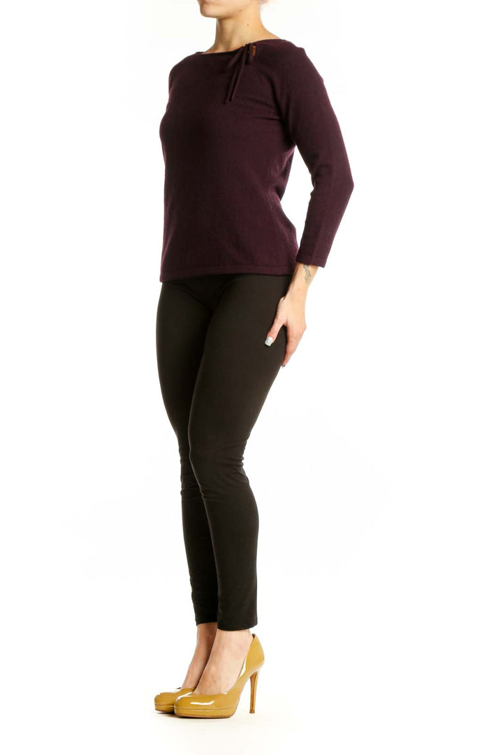 Burgundy long sleeve knit top with tie neckline detail, front view on model