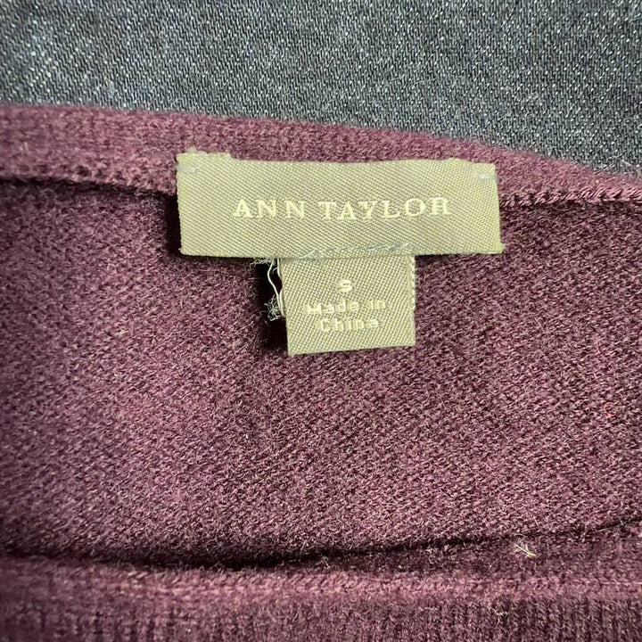 Burgundy long sleeve knit top with tie neckline detail, back view on model