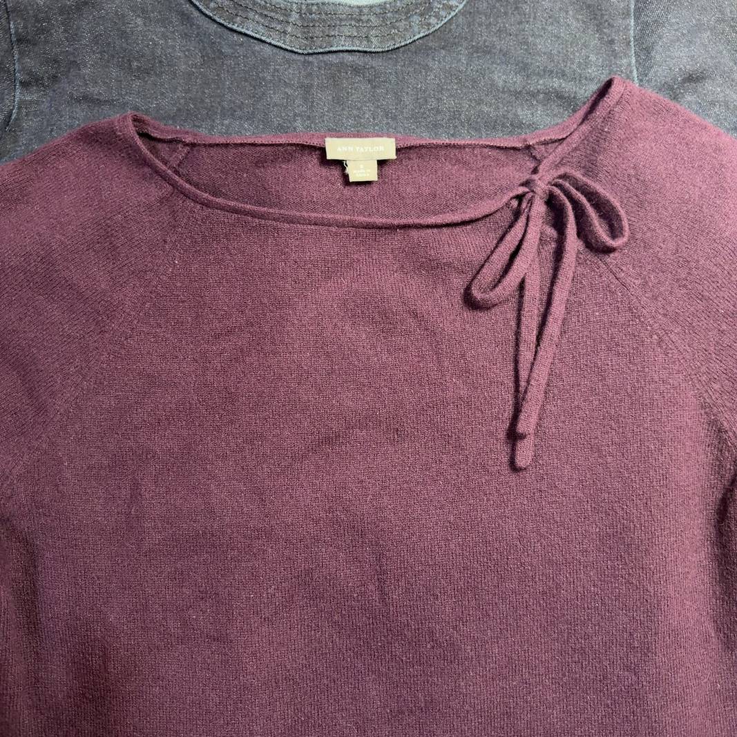 Burgundy long sleeve knit top with tie neckline detail, back view on model
