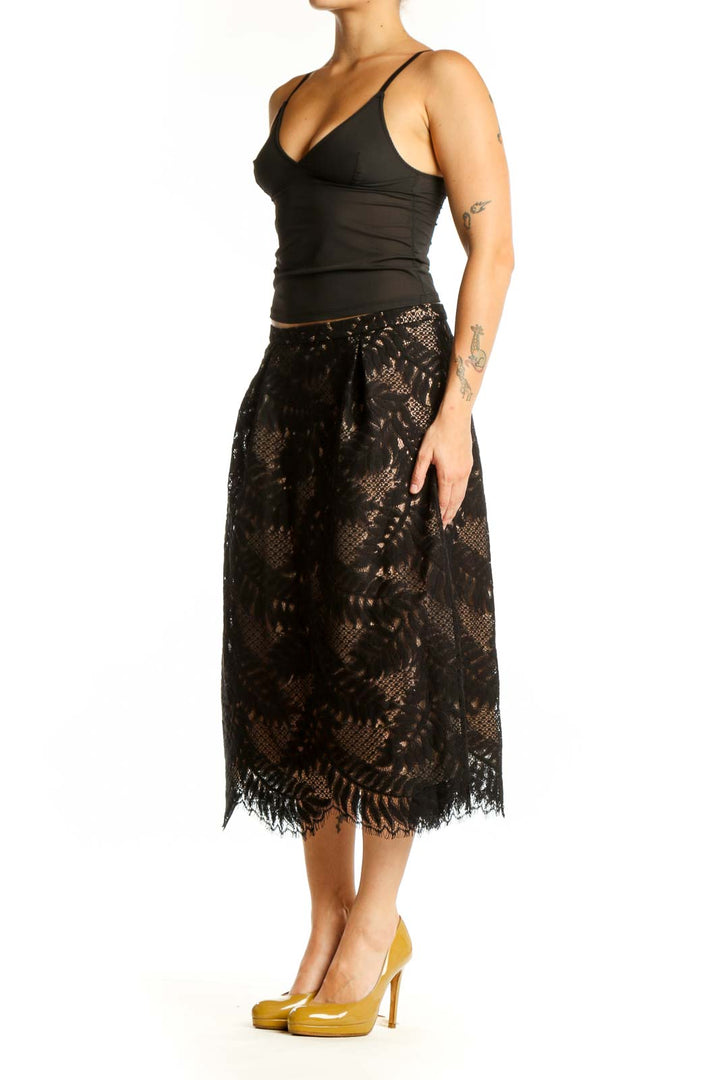 Black lace midi skirt with fringe hem and A-line silhouette, front view