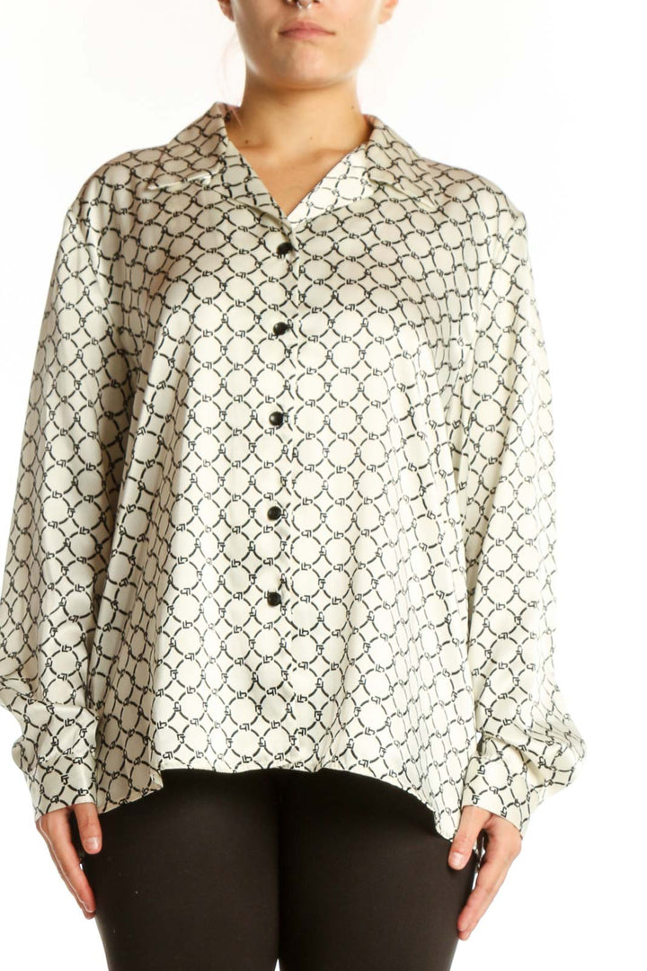 Cream geometric print button-up blouse with black pattern, front view on model