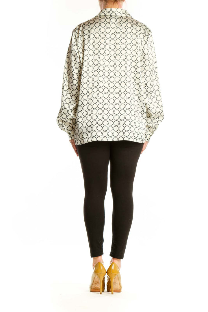 Cream geometric print button-up blouse with black pattern, back view on model