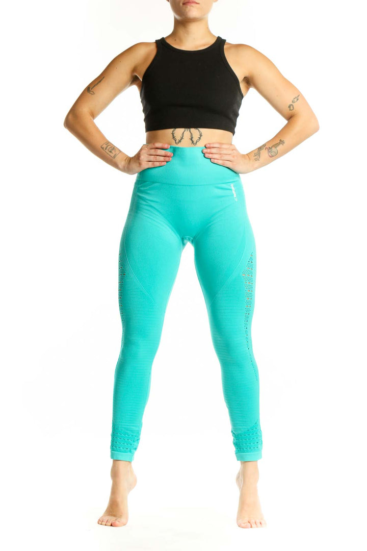 Front view of turquoise seamless cropped leggings with mesh paneling and high-waisted design