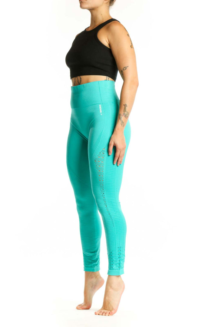 Front view of turquoise seamless cropped leggings with mesh paneling and high-waisted design