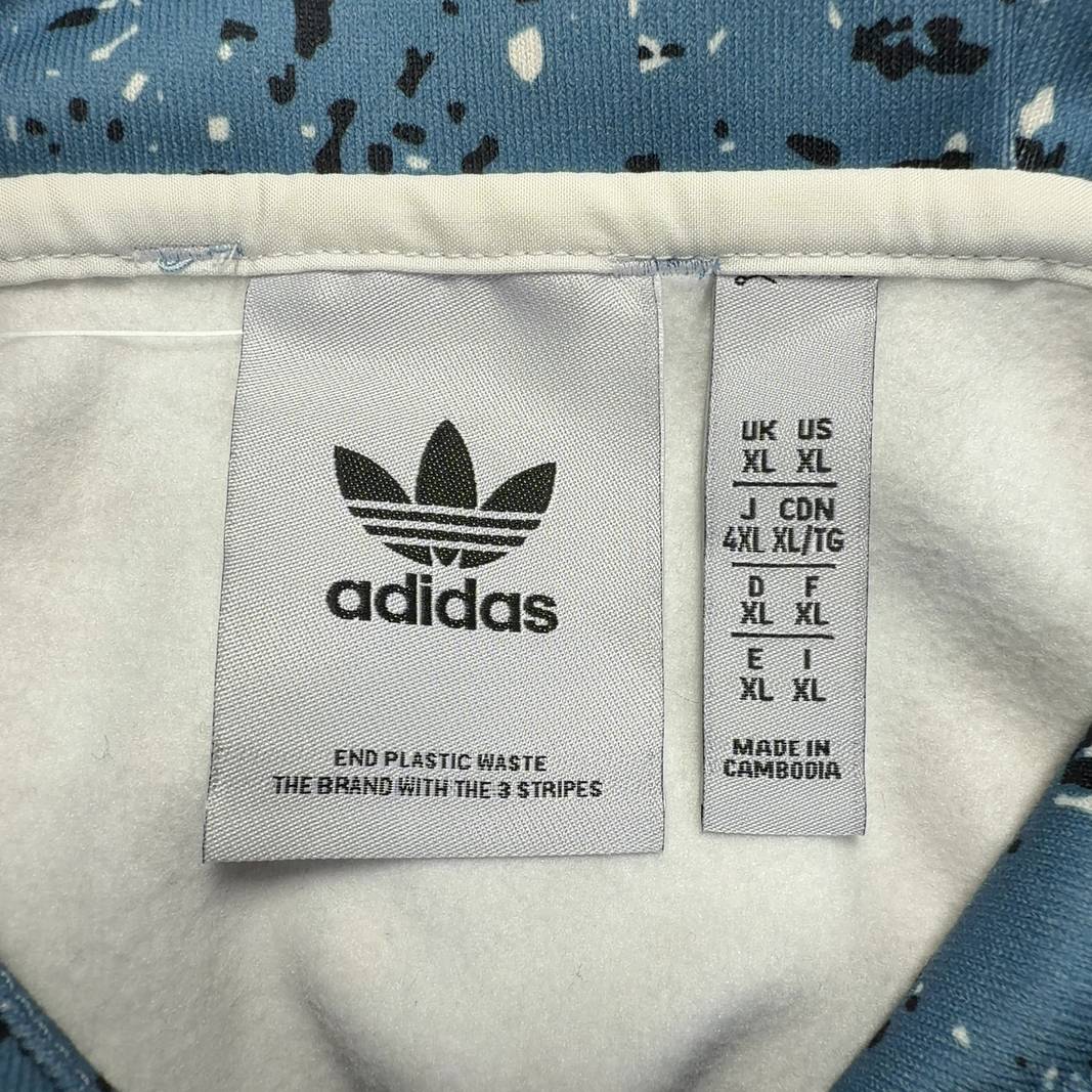 Adidas blue speckled cropped hooded jacket with drawstring hood and black contrast panel, back view on model
