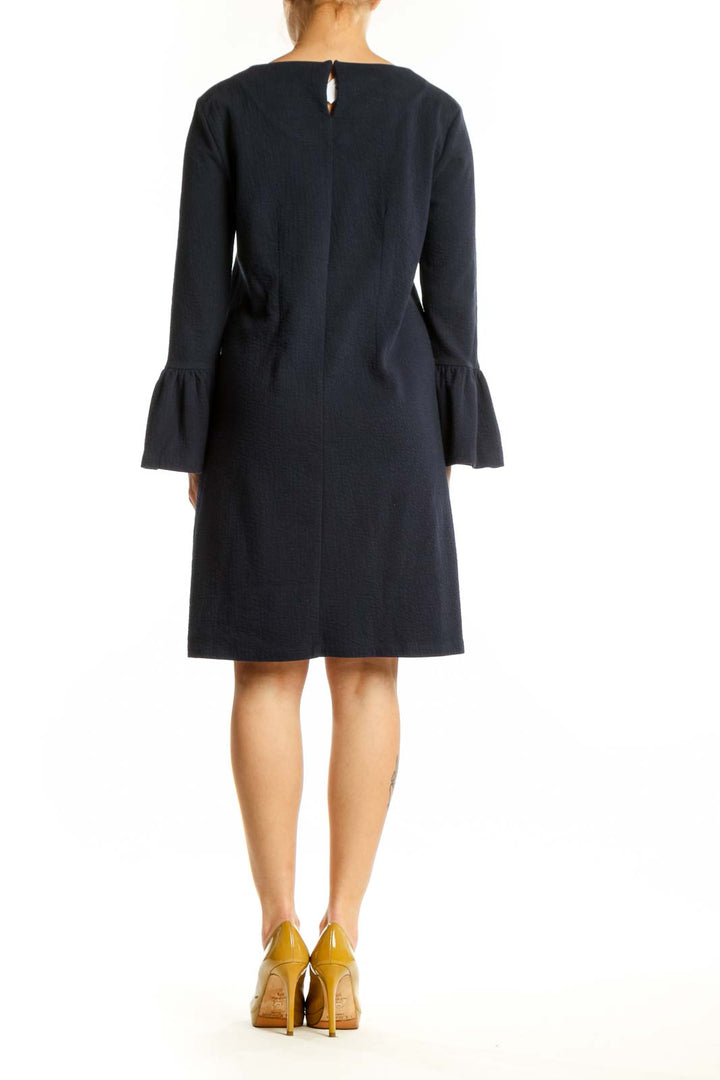 Navy bell sleeve dress back view showing elegant draping and bell sleeve detail