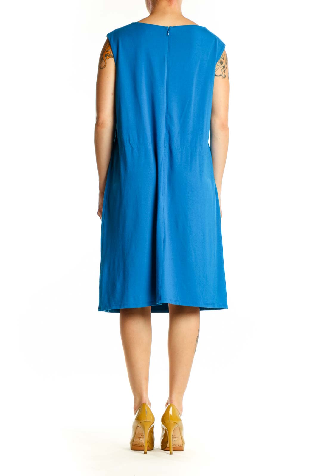 Blue twisted shoulder shift dress back view, showing relaxed shift silhouette and elegant draping