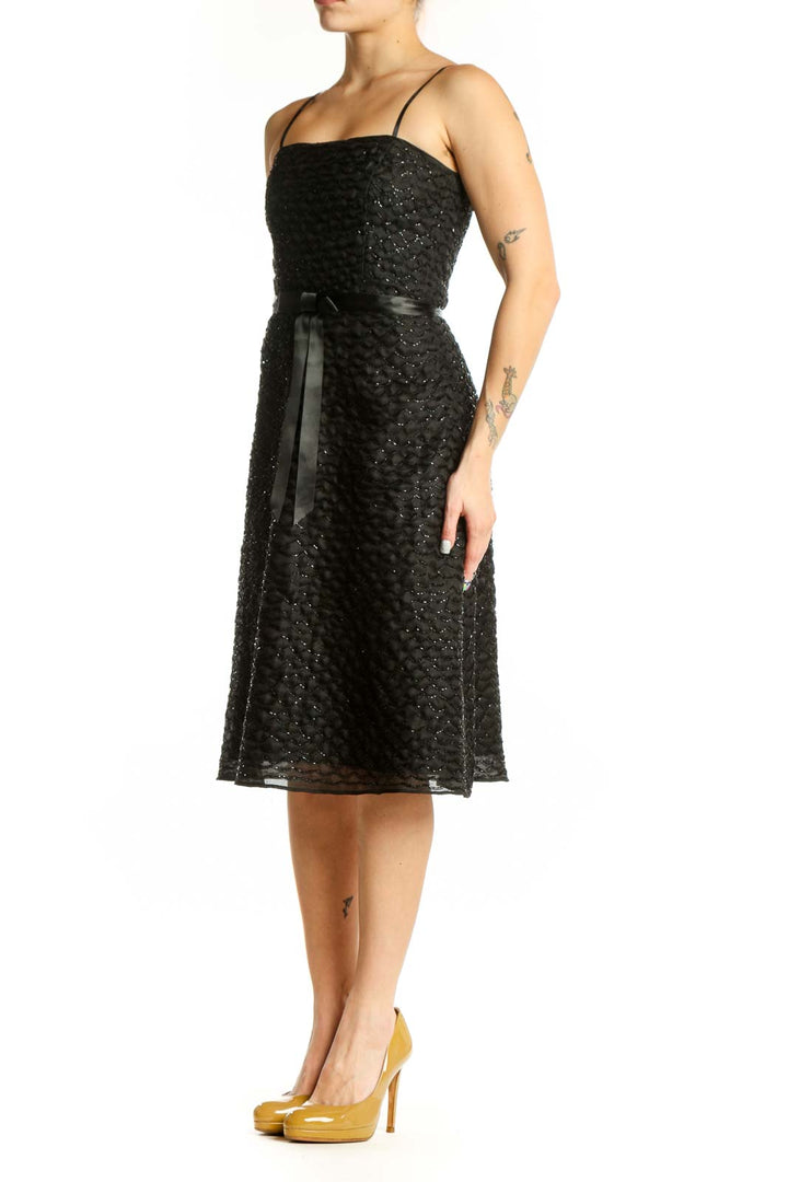 Black sequin strapless cocktail dress with silk ribbon belt, front view