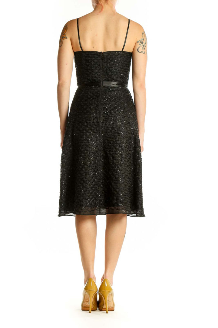Black sequin strapless cocktail dress with silk ribbon belt, back view