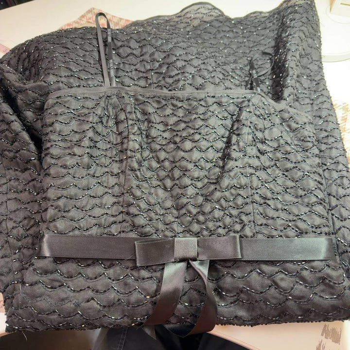 Black sequin strapless cocktail dress with silk ribbon belt, back view