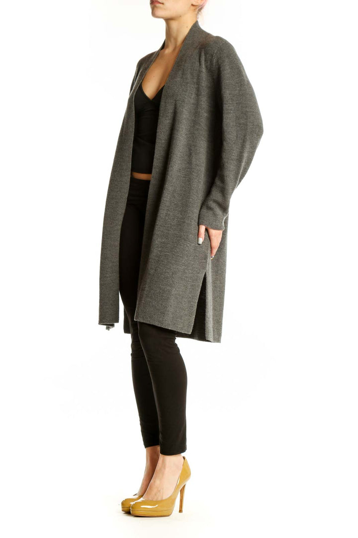 Gray merino wool open cardigan by Eileen Fisher worn over black top, front view