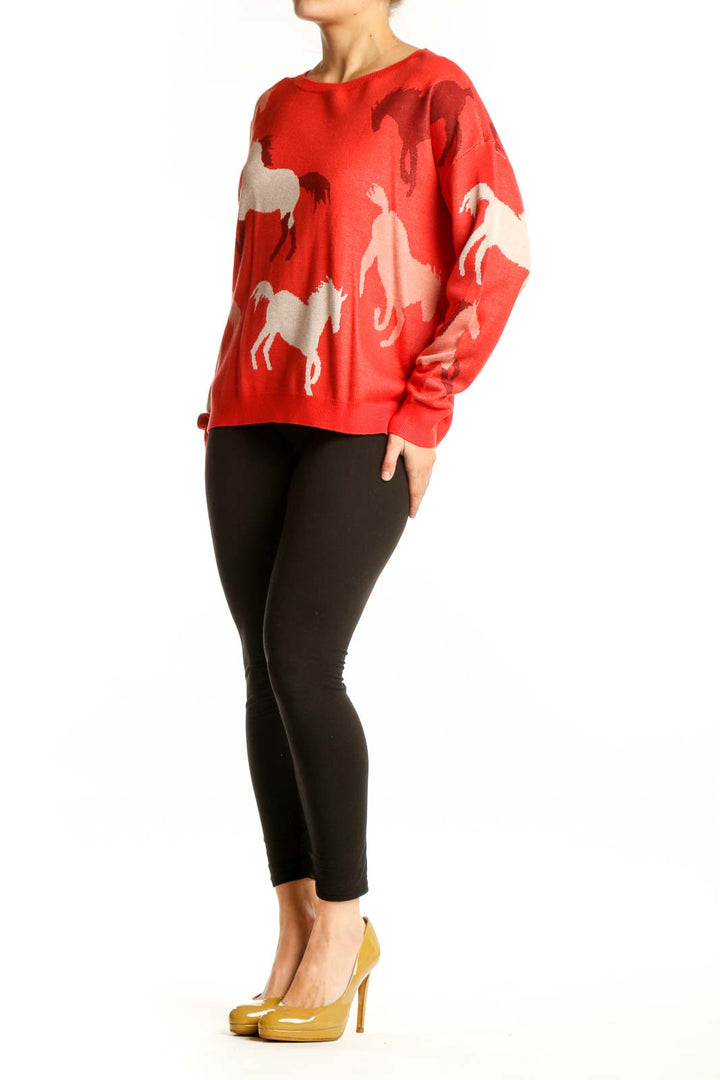 Red horse print knit sweater with cream and burgundy horse motifs, worn with black leggings
