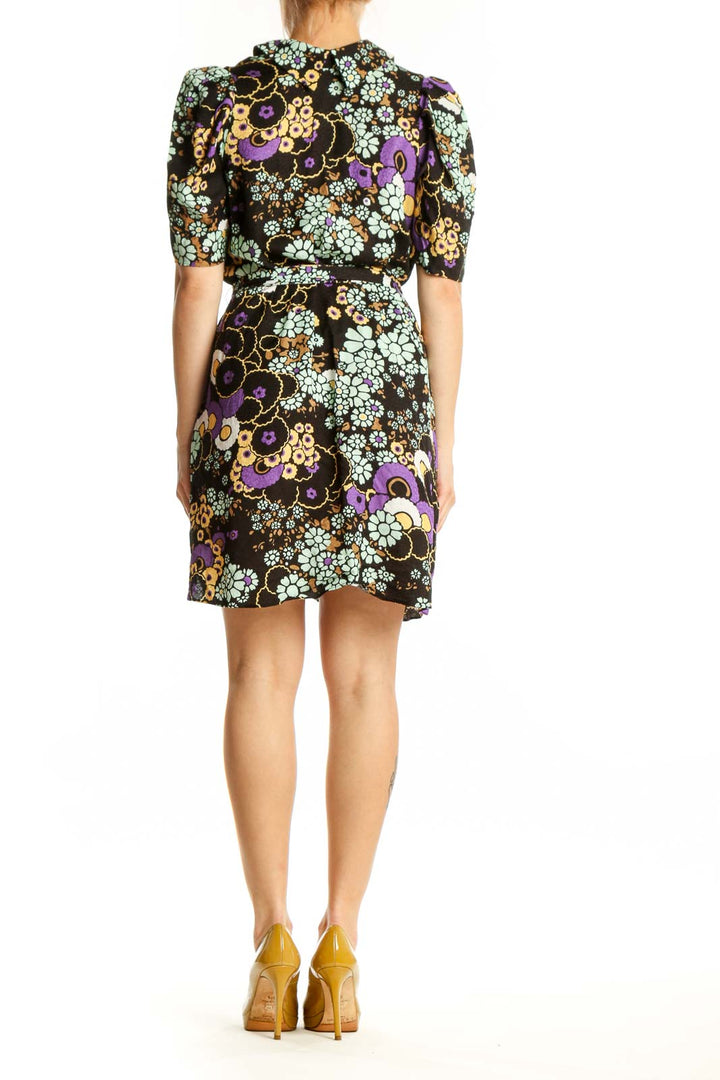 Black floral wrap dress with multicolor flowers and puffed sleeves, back view