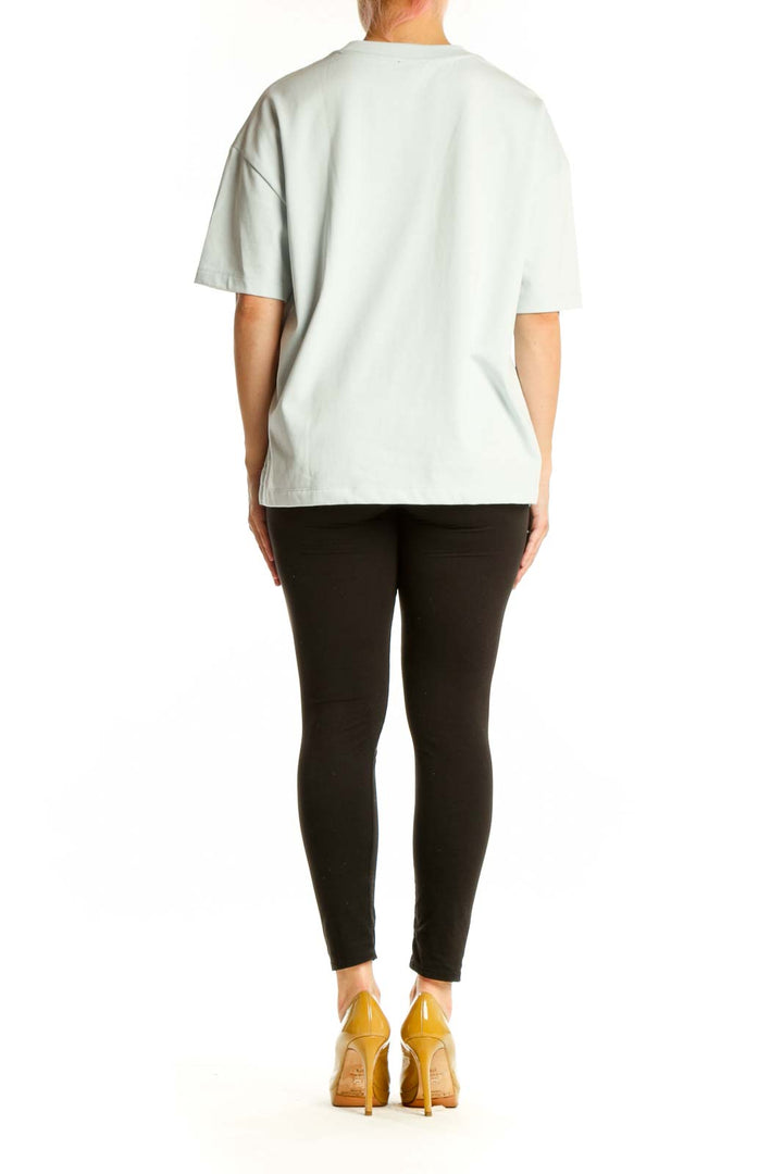 Cream oversized cotton-blend t-shirt back view showing relaxed fit and length