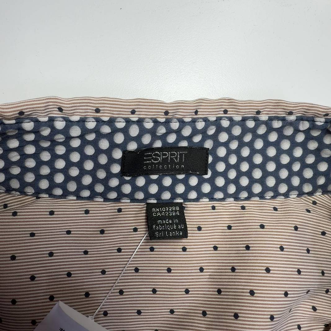 Beige polka dot button-up blouse back view showing fitted silhouette and button-down design