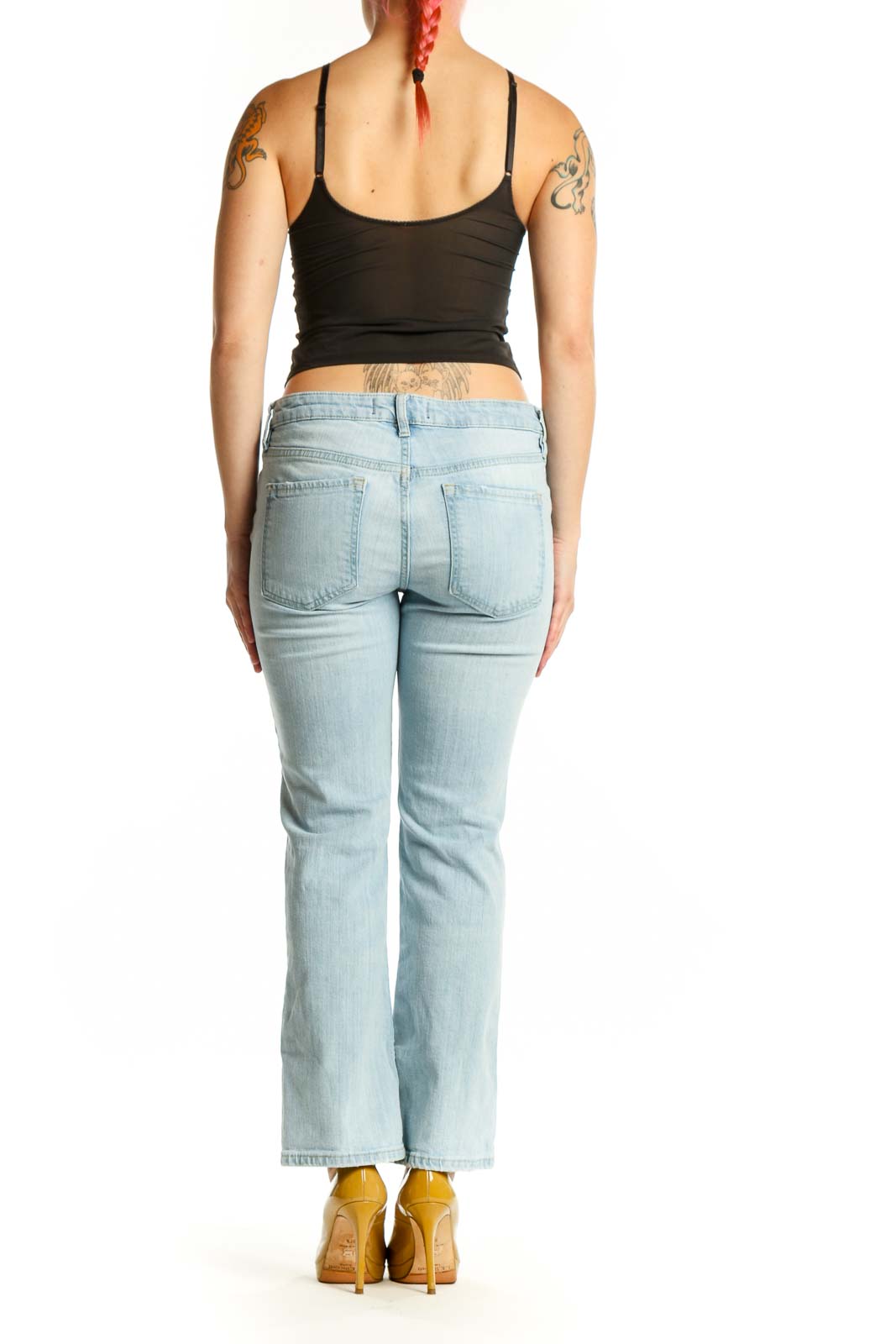 Back view of light blue denim flare jeans by WE THE FREE, size M, showing flare silhouette and five-pocket construction
