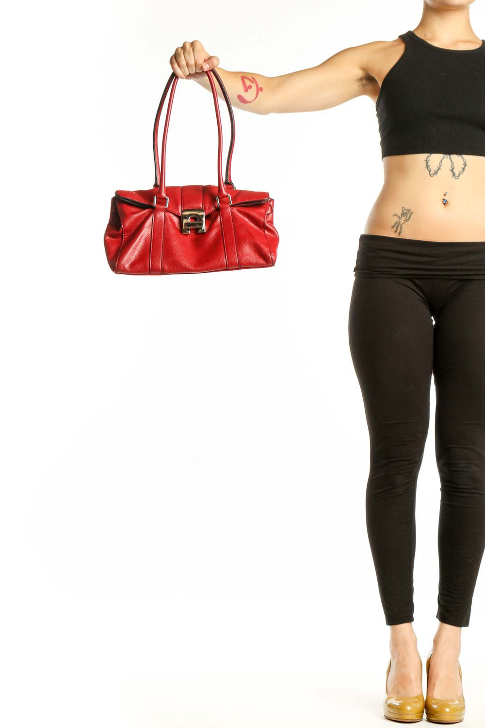 Red leather shoulder bag with pleated detailing and gold-tone hardware held by model