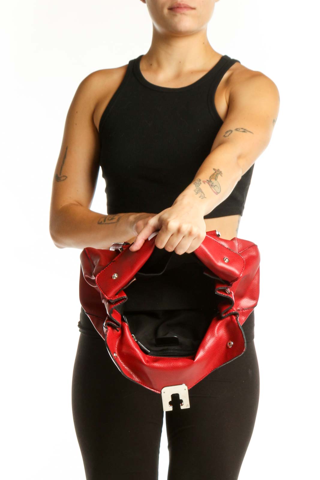 Back view of red leather shoulder bag with dual shoulder straps worn by model