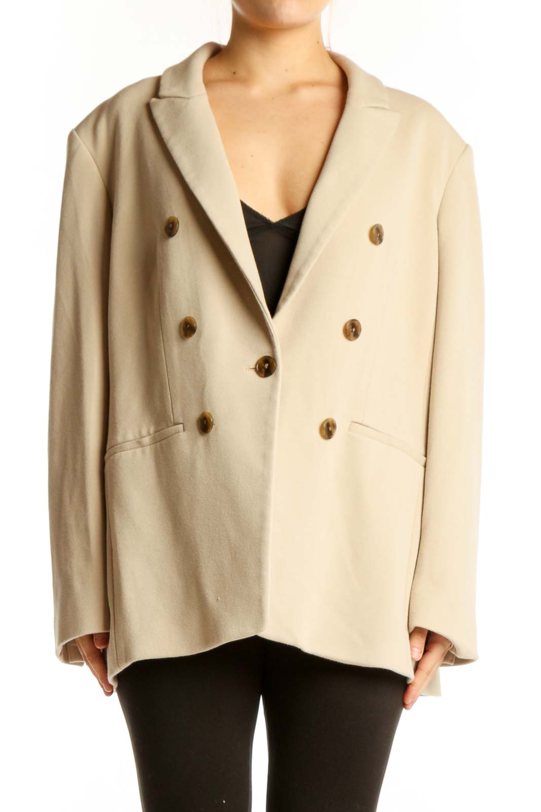 Cream double-breasted blazer with brown buttons, front view on model
