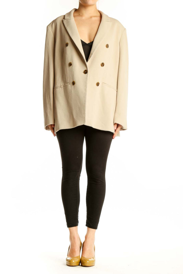 Cream double-breasted blazer with brown buttons, front view on model