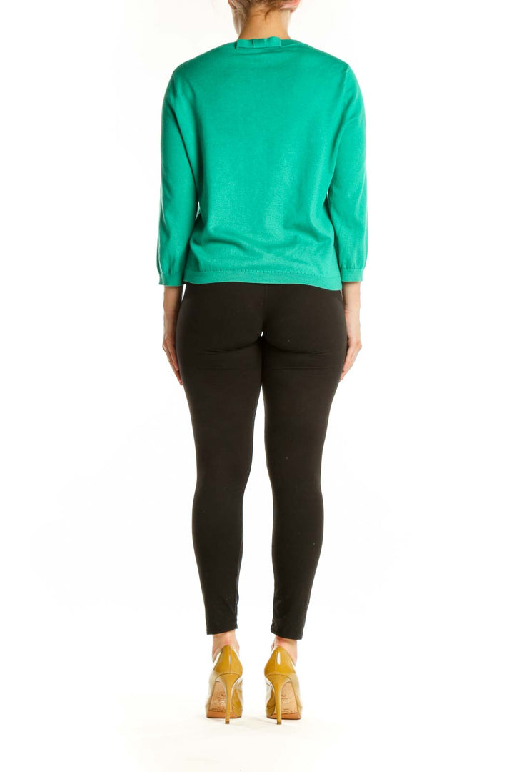 Back view of Kate Spade green cardigan showing classic silhouette and button detailing