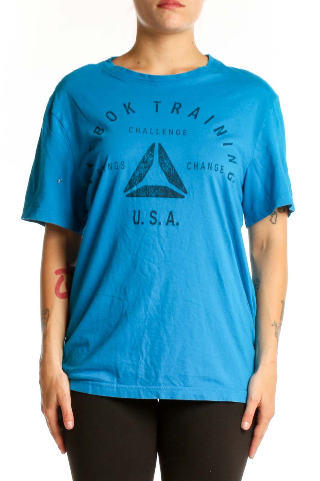 Blue Reebok graphic t-shirt with Book Training Challenge logo and triangle design, front view on model