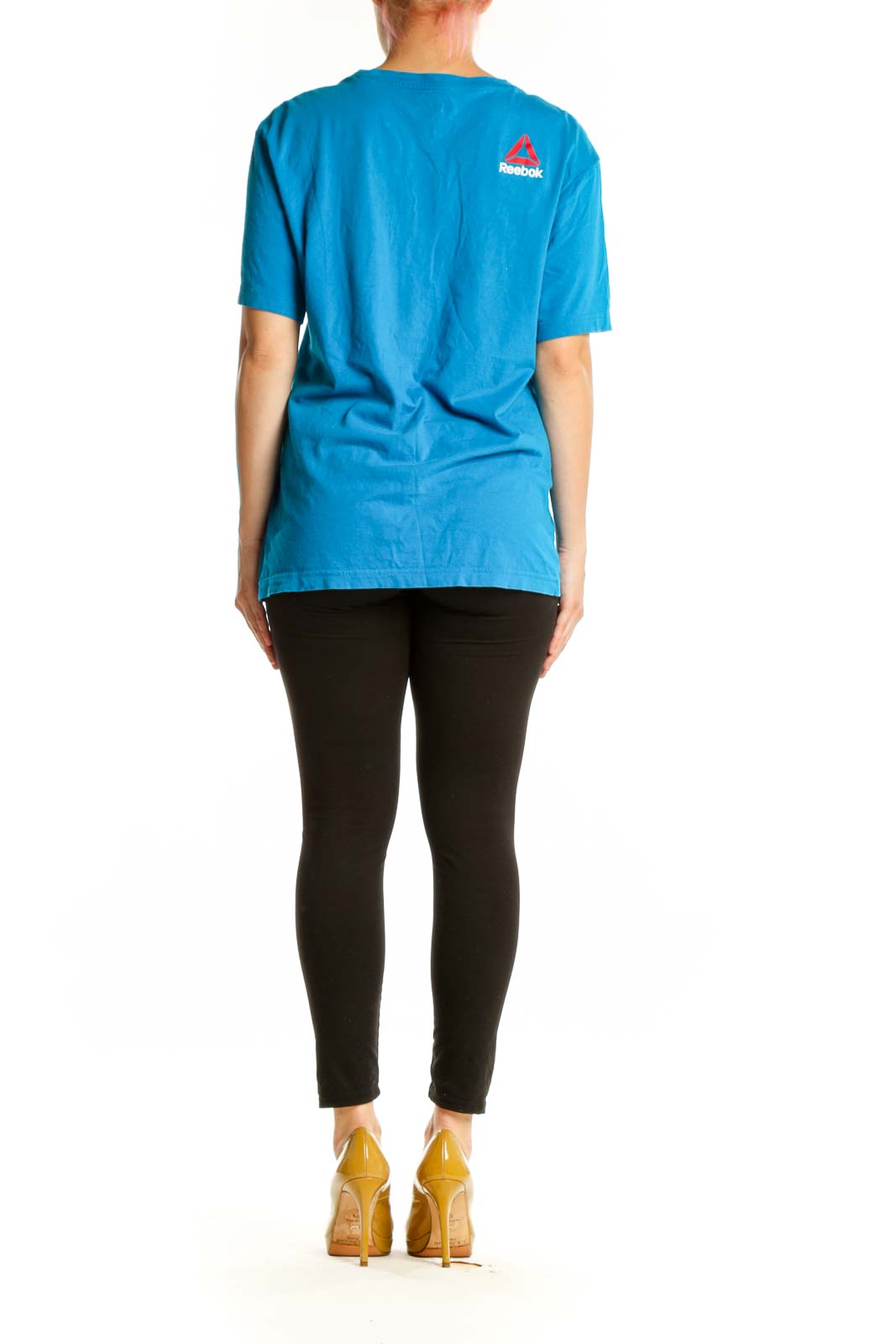Blue Reebok graphic t-shirt back view showing distressed graphic design, worn with black leggings