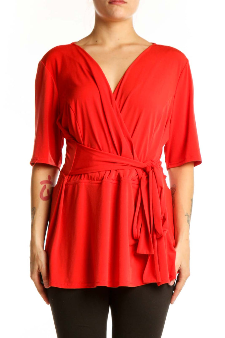 Red wrap blouse with tie waist and three-quarter sleeves, front view on model